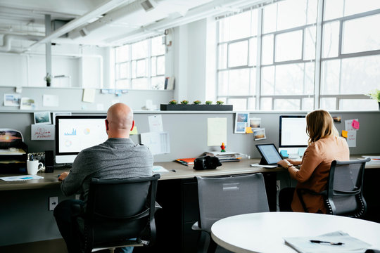 Workers using computers in office