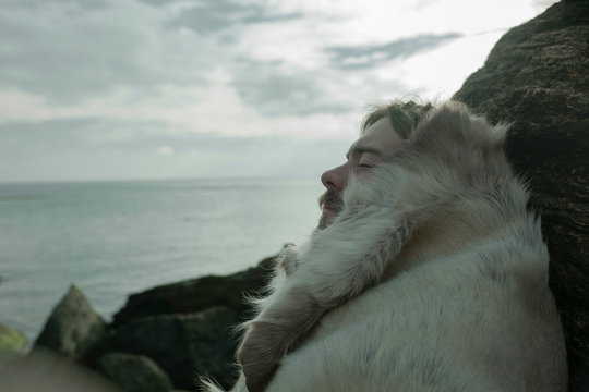 portrait of a guy in the skin of an animal on the background of the sea