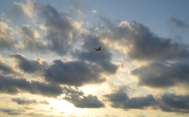 Jet flying into the sunset from airport