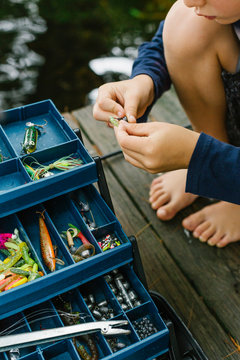 Young Boy Fishing on Dock with Tackle Box