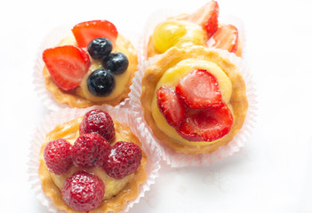 cupcakes with fresh seasonal fruit. Fresh fruit tart with cream and jelly