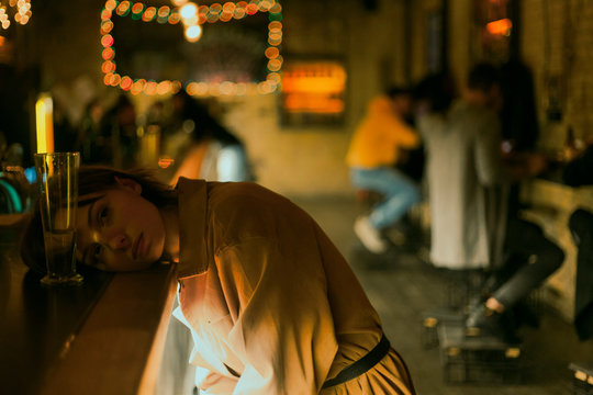 cinematic portrait of a girl with a glass of wine at bar