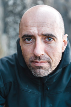 Bald bearded man in coat