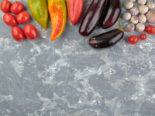 Fresh vegetables lying on a light gray concrete table background