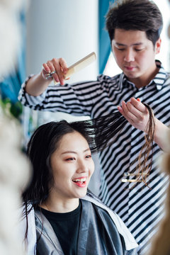 Hairdresser cutting hair in hair salon