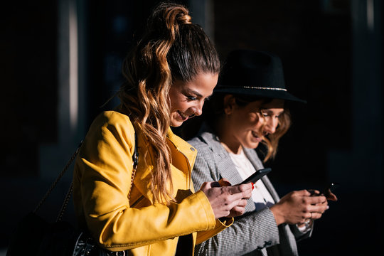 Stylish young women using mobile phone