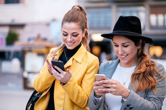 Stylish young women using mobile phone