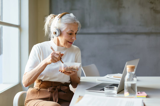 Woman working on laptop in a modern workspace.