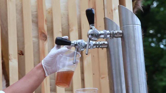 pouring beer into plastic cup