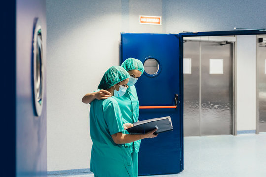 Female Doctors Walking In Hallway Together