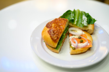 Bagel With Smoked Salmon And Vegetables Served On Table