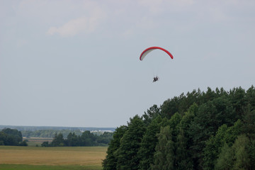 Romantic moto paragliding flights over the fields.