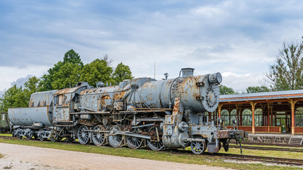 Fototapeta na wymiar Old steam locomotive in old vintage style railway station in Haapsalu; Estonia