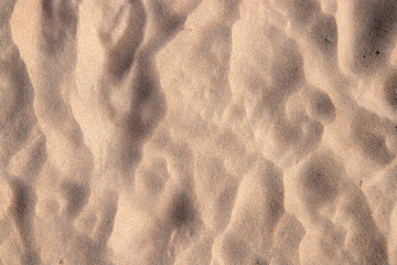 Beach sand texture with step marks. Sandy seashore top view photo. Tropical beach minimal banner template.