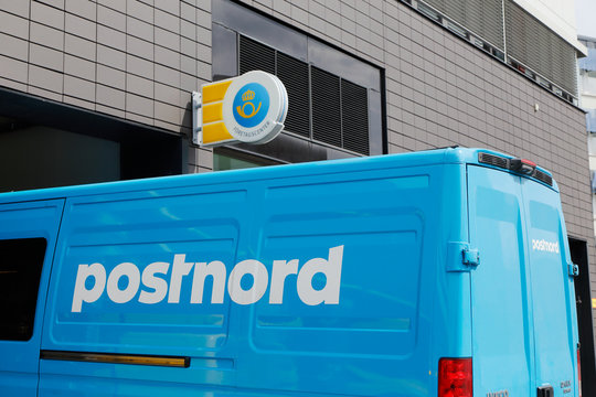 Solna, Sweden - June 15, 2016: A blue van marked with Postnord the Swedish postal service parket outside the office at the street  Englundavagen in  Solna Buissness park.