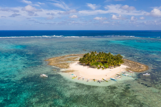 Guyam island, Siargao, Philippines. Small island with palm trees and a white sandy beach. Philippine Islands.