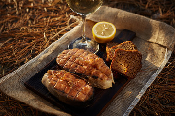 Cooked salmon steaks and ingredients on a old wooden board