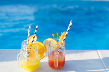 Two Colorful Tropical Cocktails near the Swimming Pool
