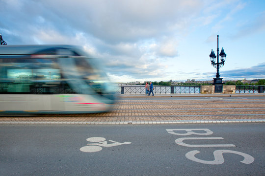 Tramway passing on Pont de Pierre, or the stone bridge in Bordeaux, France