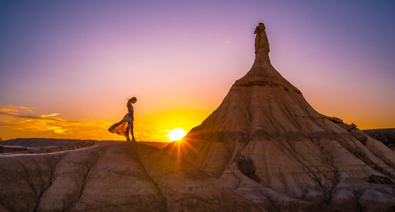 Lifestyle session of a girl with a dress at sunset in the Castildestones de las Bardenas. Navarre