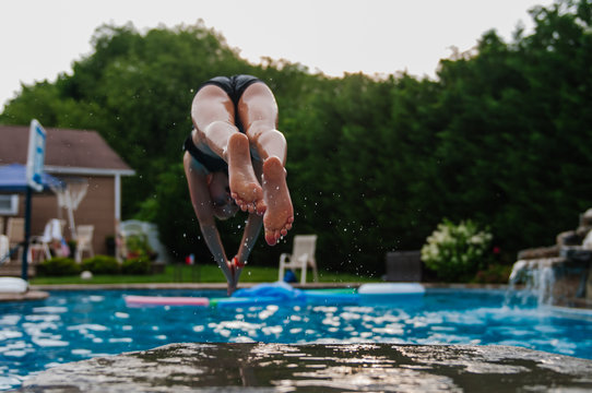 Behind view of girl diving into pool