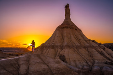 Fototapeta premium Lifestyle session of a model with a dress at Castildepiedra de las Bardenas, Navarra. Spain