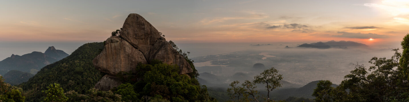Landscape of rocky mountain peak on rainforest sunset