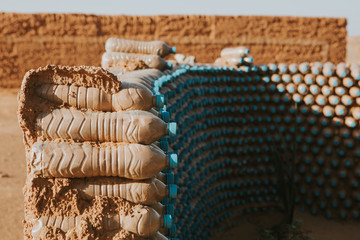Plastic bottles forming a wall with mud in Morocco. Recycling concept.