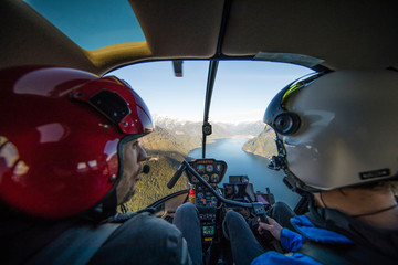 Flight instructor teaching student pilot how to fly a helicopter