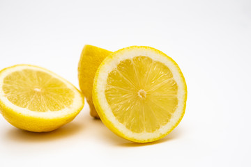 Fototapeta na wymiar Freshly cut lemon. Sliced ​​lemon on white background.