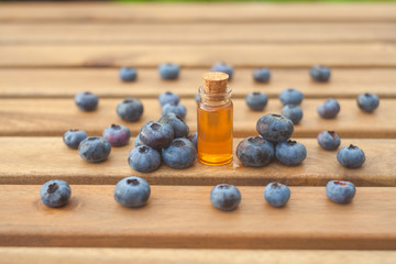 Essence of blueberry on Wooden  background in beautiful glass jar