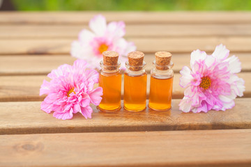 Essence of  flowers on table in beautiful glass Bottle