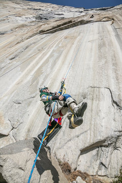 Adaptive climber ascends a rope on zodiac