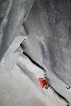 A climber ascends an impressive looking jagged flake high up on el cap