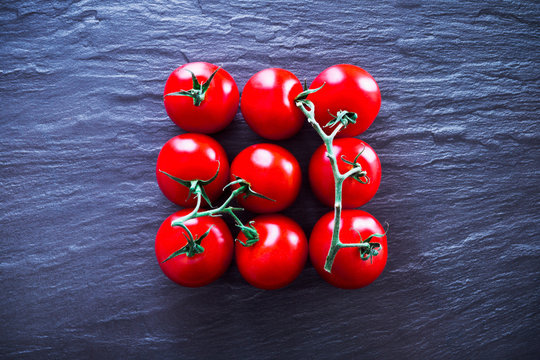 Top view of fresh tomatoes against slate