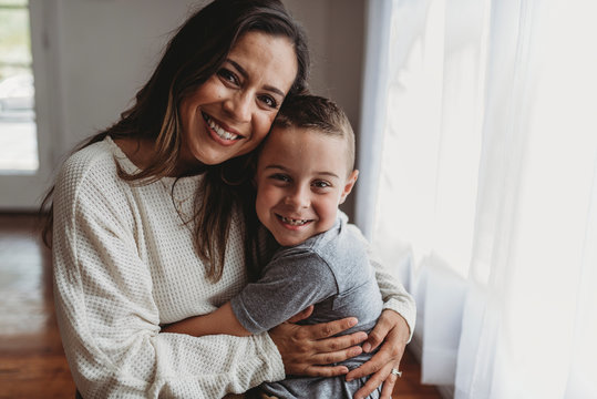 Portrait of mother and son looking at the camera in studio