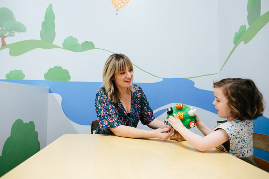 Teacher smiles at student