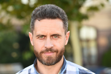 Naklejka premium Barber salon. Handsome bearded guy portrait close up. Facial hair and skin care concept. Handsome face. Handsome mature man unshaven stylish bristle. Caucasian man urban background. Ageing, grey hair