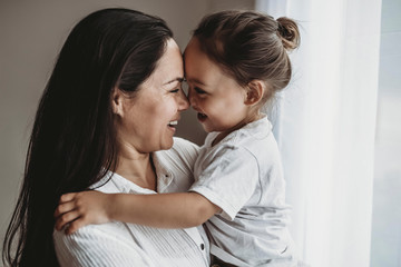 Side view of young mother and toddler boy looking at each other