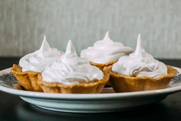 Crispy tartlets with white whipped egg cream
