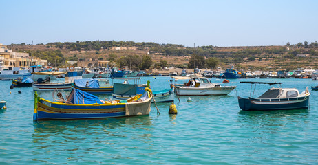 Fototapeta na wymiar Traditional fishing boats Luzzu moored