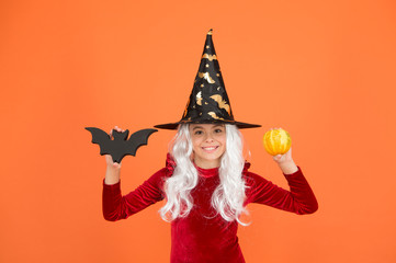 Little child in witch costume. Halloween party. Small girl in black witch hat. Autumn holiday. Join celebration. Magical spell. Small witch with white hair. Wizard or magician. Halloween attributes