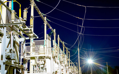 High-voltage electrical substation at night