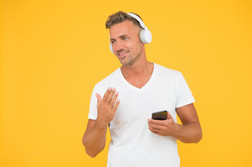 Favorite music playlist. Music subscription. Man listen music modern headphones and smartphone....