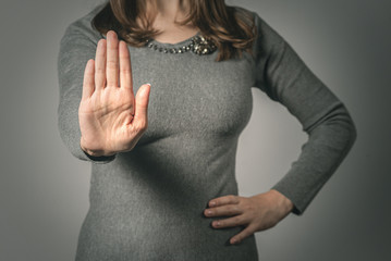 Woman showing a refuse hand gesture sign.