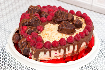Delicious dietary food. Vegan cake for lovers with red raspberries, chocolate and cashew cream on top.