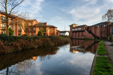Obraz premium A view over the Shropshire Union canal showing a typical canal barge, Chester, England.