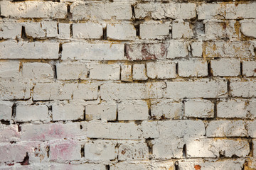 The texture of the old wall of brick painted white