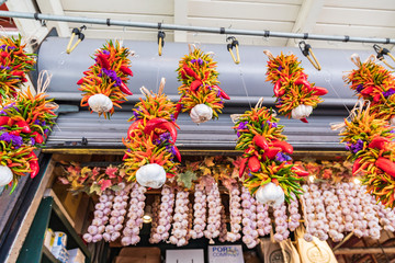 USA, Washington State, Seattle, Pike Place Market. Chili pepper strings and garlic for sale.