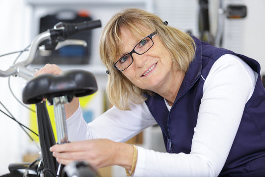 portrait of senior female bicycle mechanic - Powered by Adobe